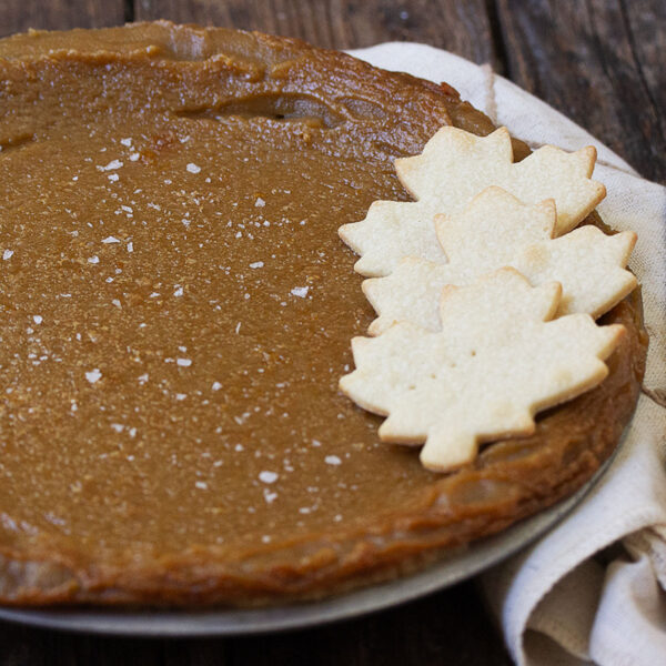 maple syrup pie in pan with pastry maple leaves on top