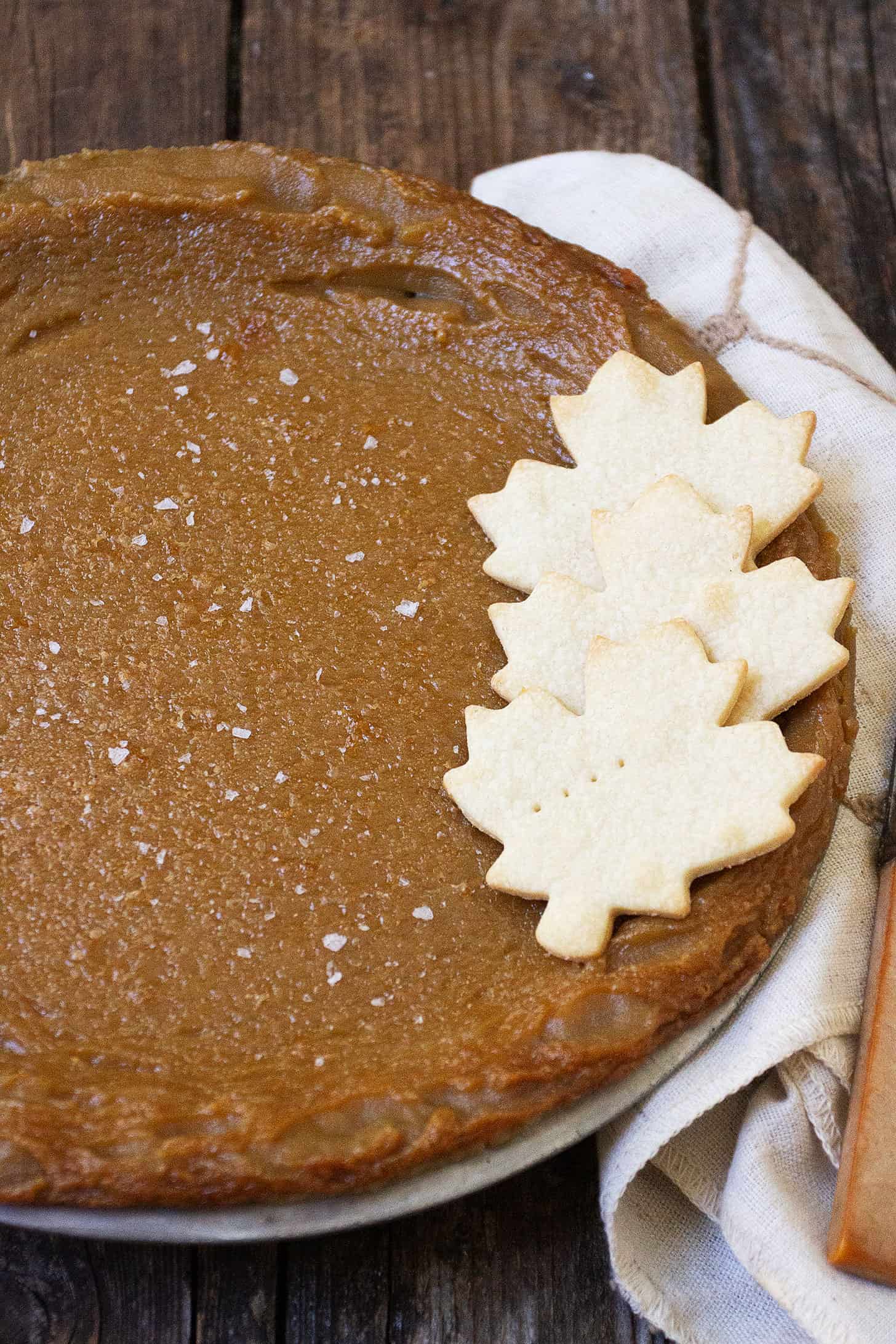 maple syrup pie in pan with pastry maple leaves on top