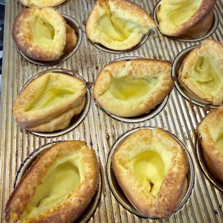 Mini Dutch baby pancakes in the muffin tin after baking.