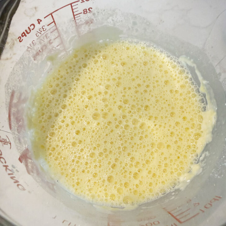 Finished mini Dutch baby pancake batter in a measuring cup.