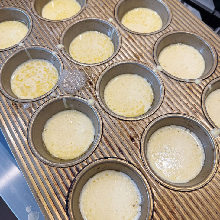 Muffin cups filled with batter before baking.