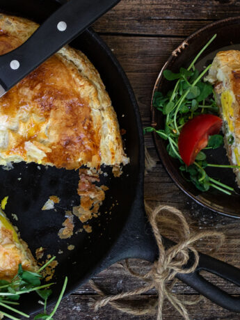 skillet bacon and egg pie with a slice on a plate
