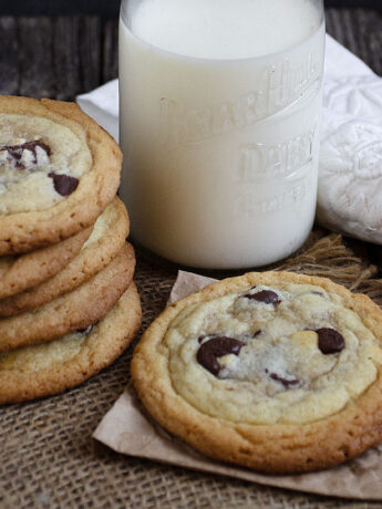 double layer cookies on table with milk