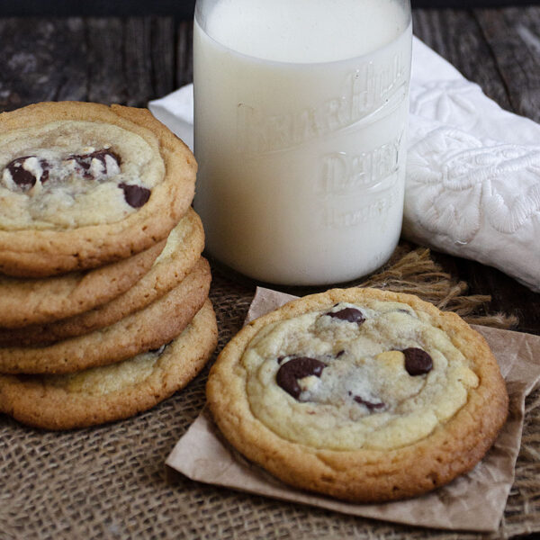 double layer cookies on table with milk