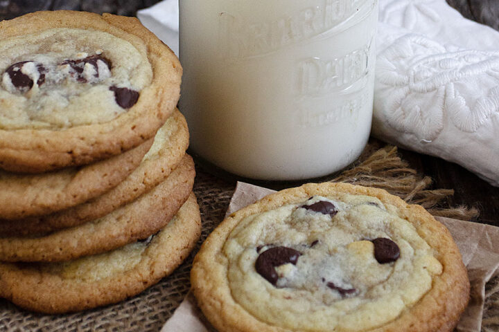 double layer cookies on table with milk