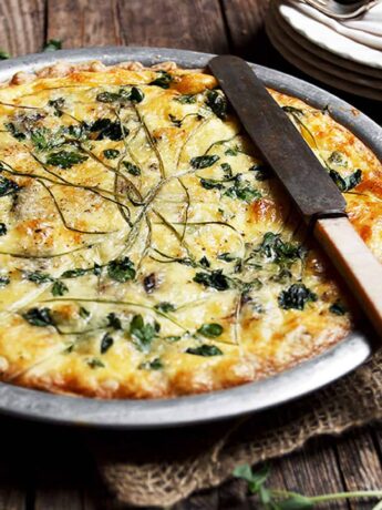 fiddlehead quiche in pie plate with knife