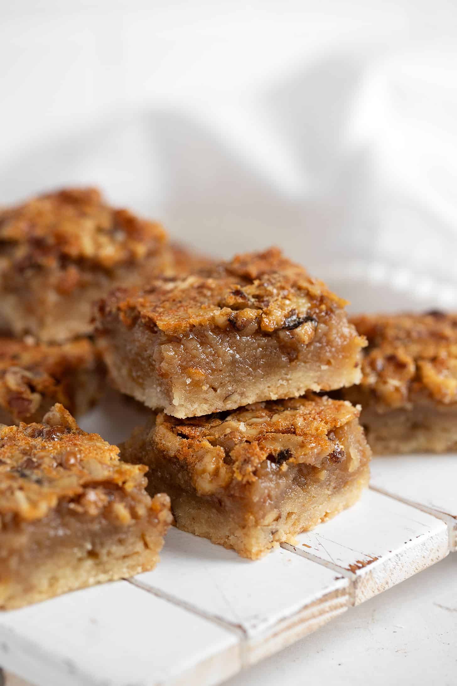 Maple walnut squares cut and stacked on a serving board.