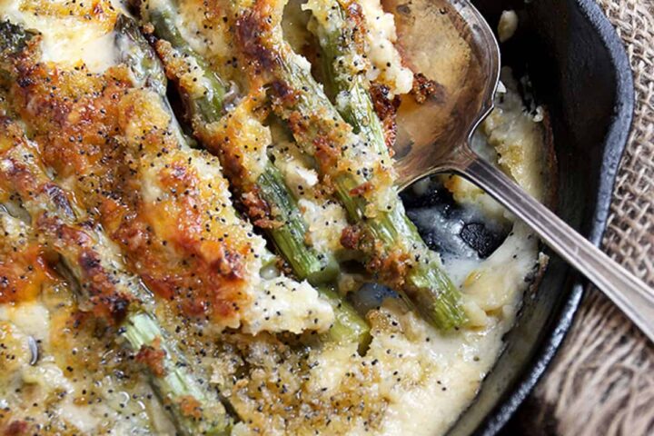 baked asparagus with cheese sauce in skillet