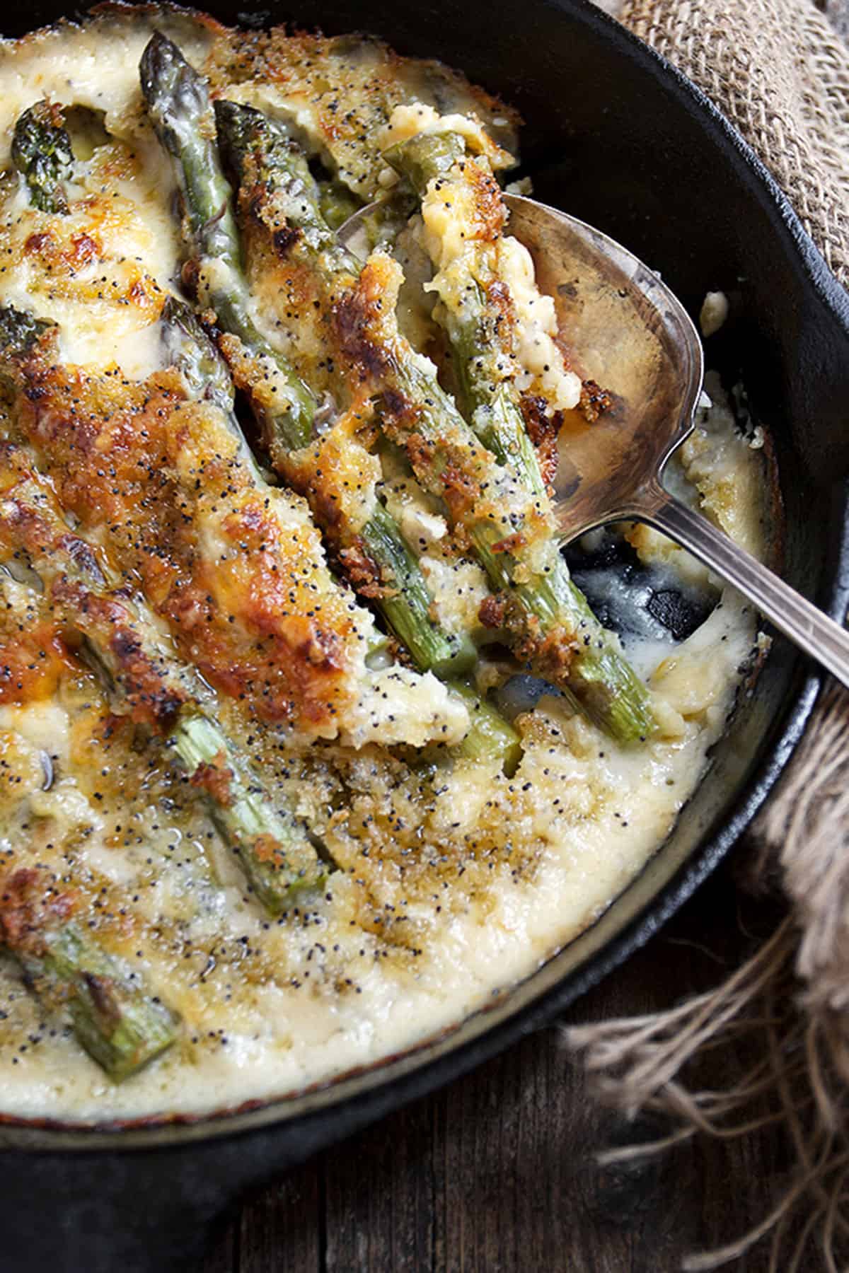 baked asparagus with cheese sauce in skillet