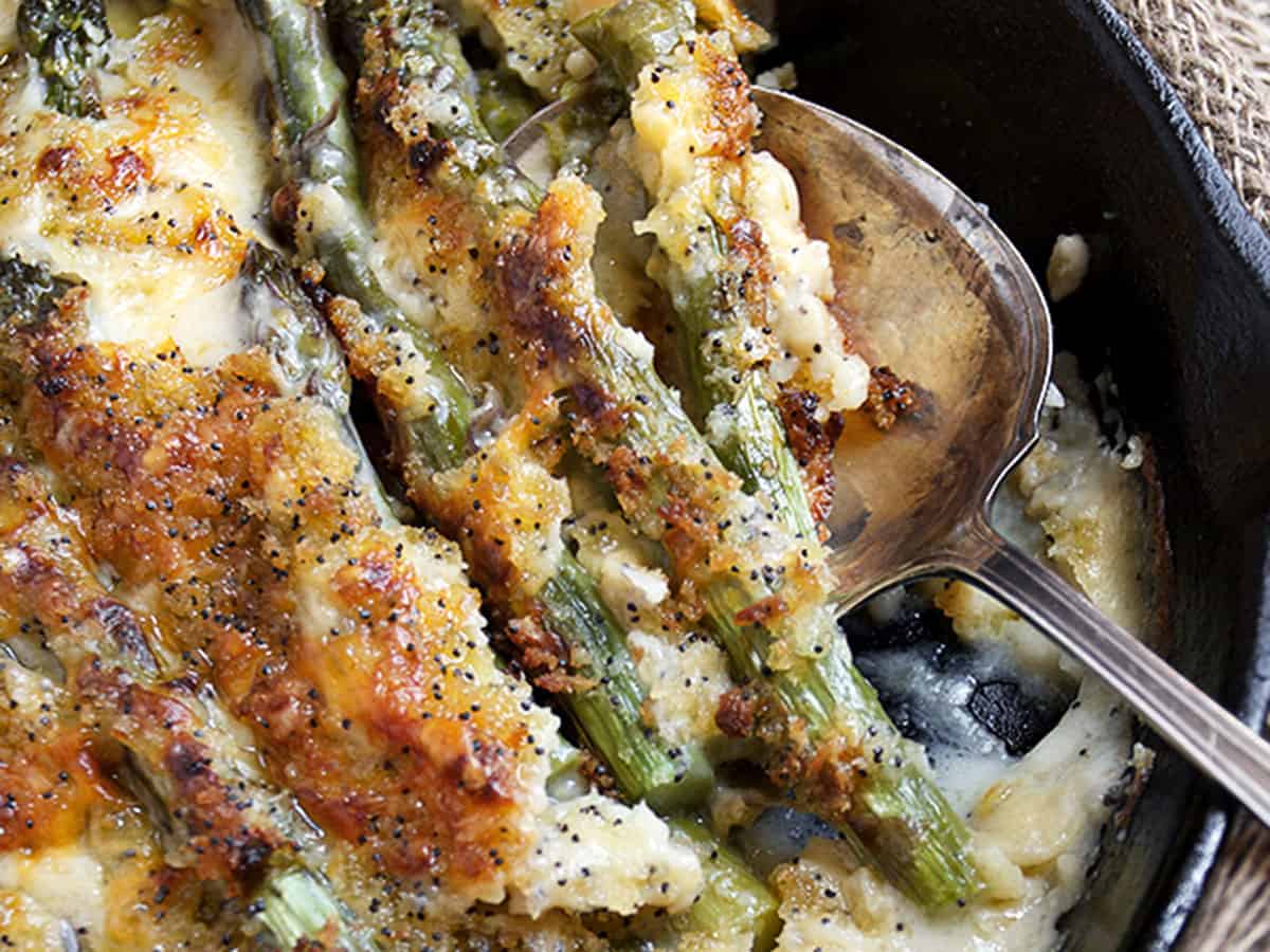 baked asparagus with cheese sauce in skillet