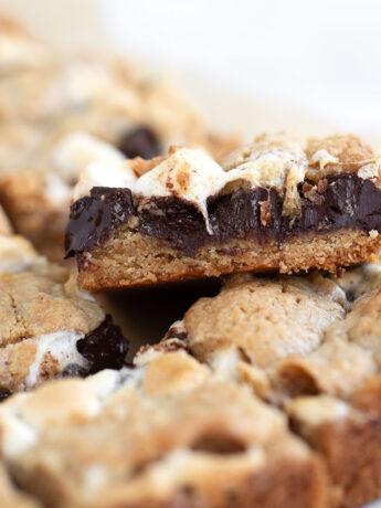 S'mores cookie bars cut on parchment paper.