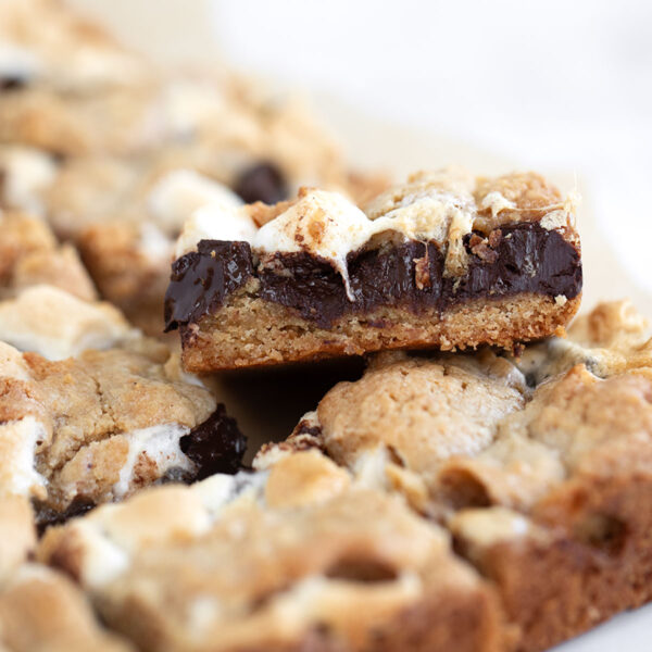 S'mores cookie bars cut on parchment paper.