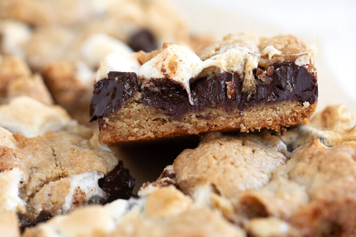 S'mores cookie bars cut on parchment paper.
