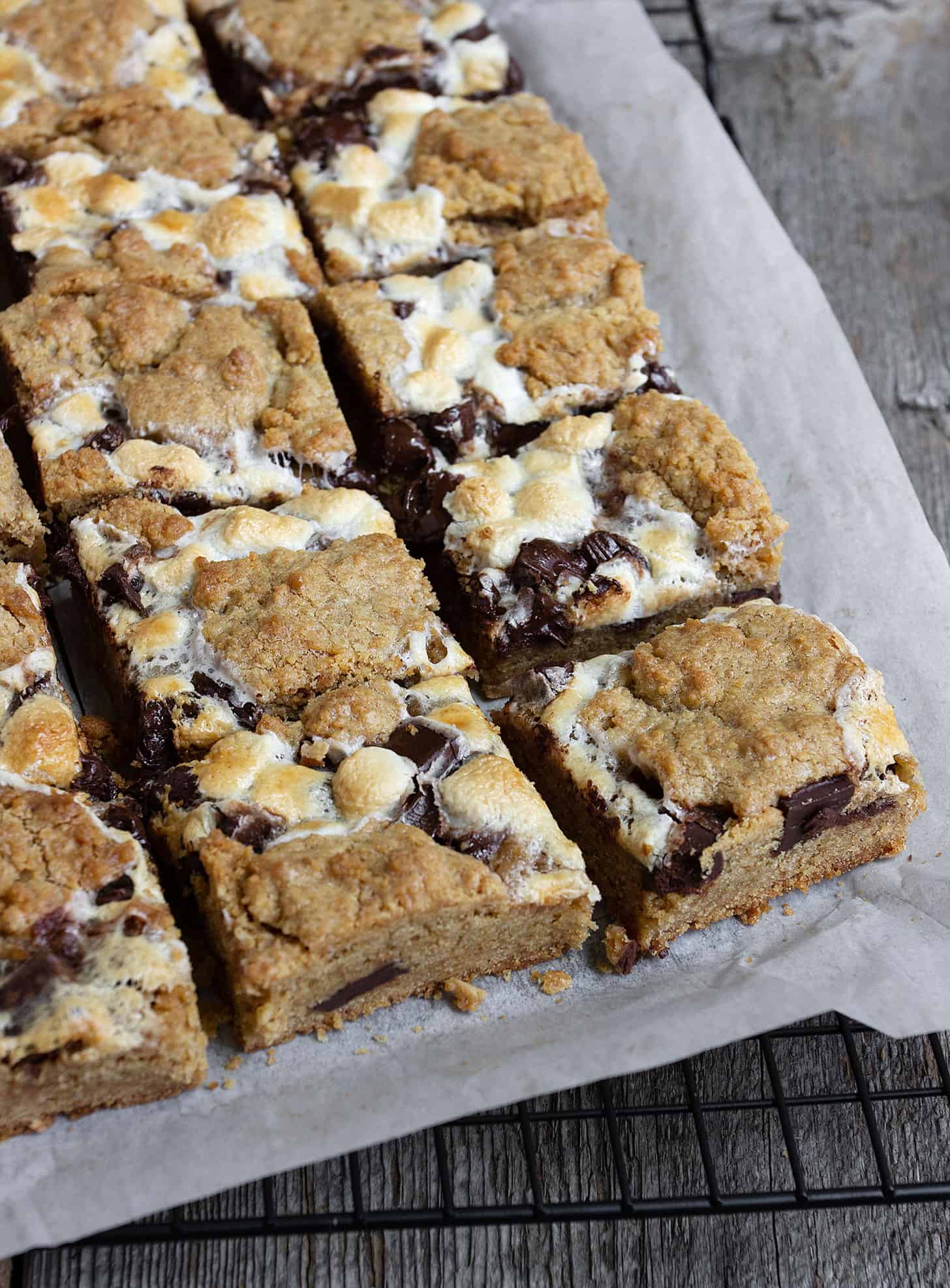 smores cookie bars cut on parchment paper