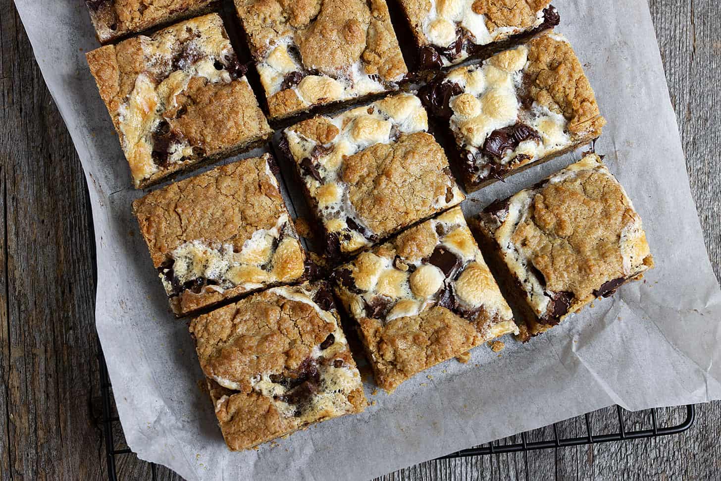 smores cookie bars cut on parchment paper