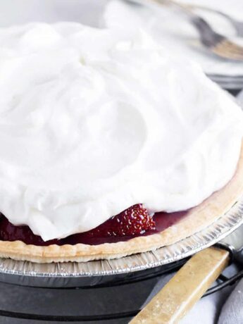 strawberry glaze pie on rack with knife