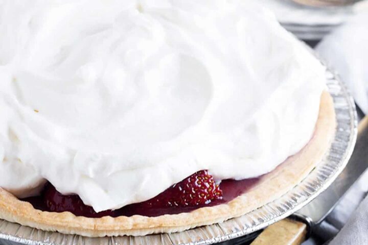 strawberry glaze pie on rack with knife