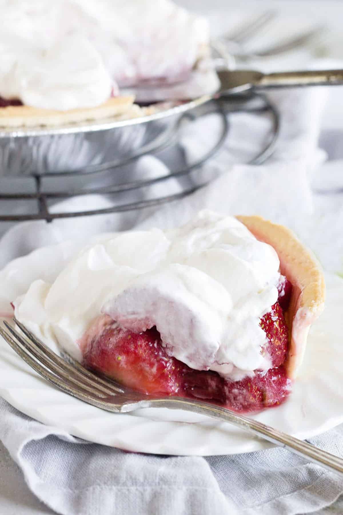 strawberry glaze pie on rack with knife