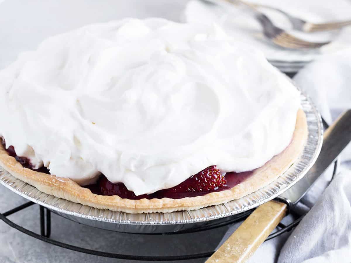 strawberry glaze pie on rack with knife