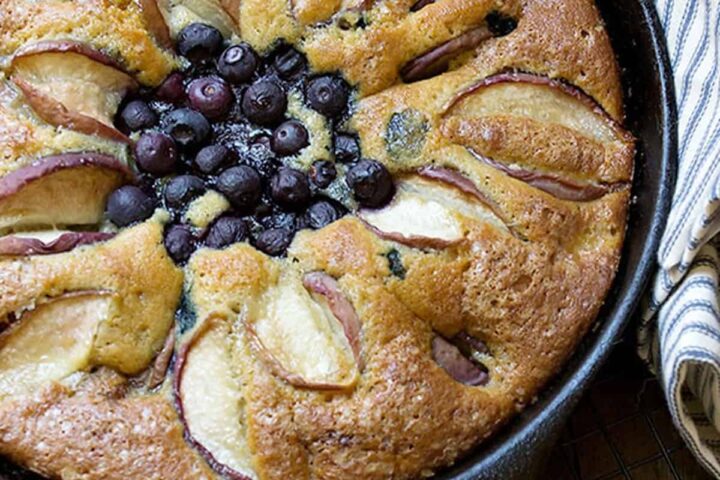 blueberry and peach cake in cast iron skillet