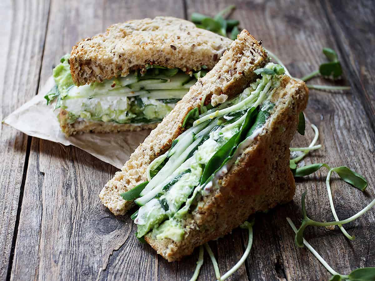 green goddess sandwich on wood background