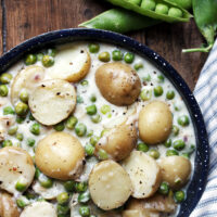 creamed peas and potatoes in skillet