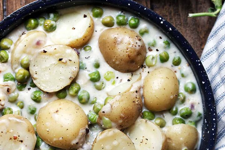 creamed peas and potatoes in skillet
