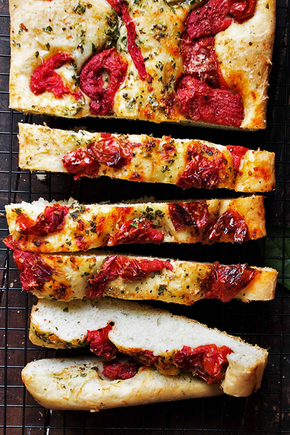 tomato focaccia sliced on cooling rack