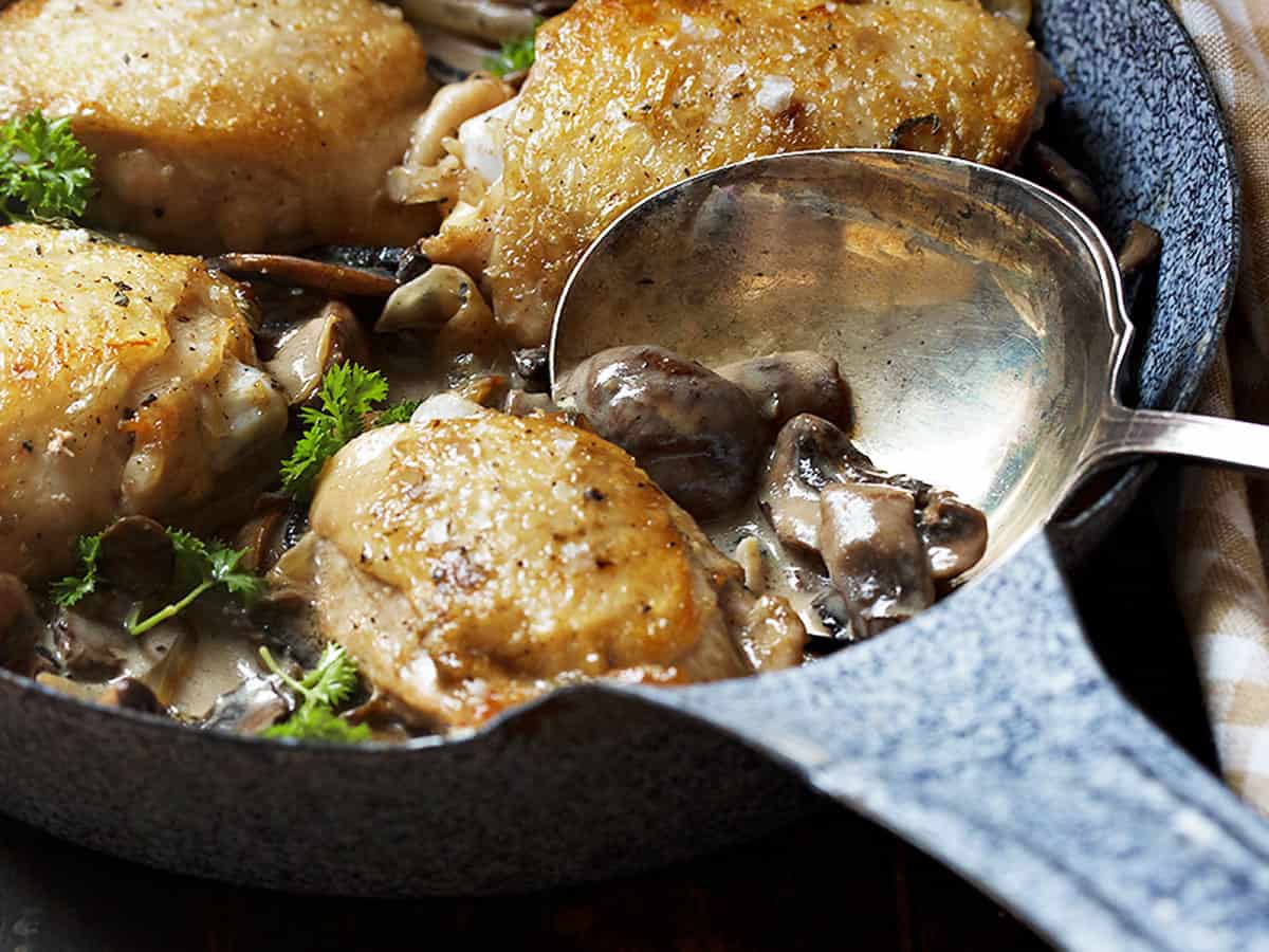 chicken thighs with mushrooms in pan