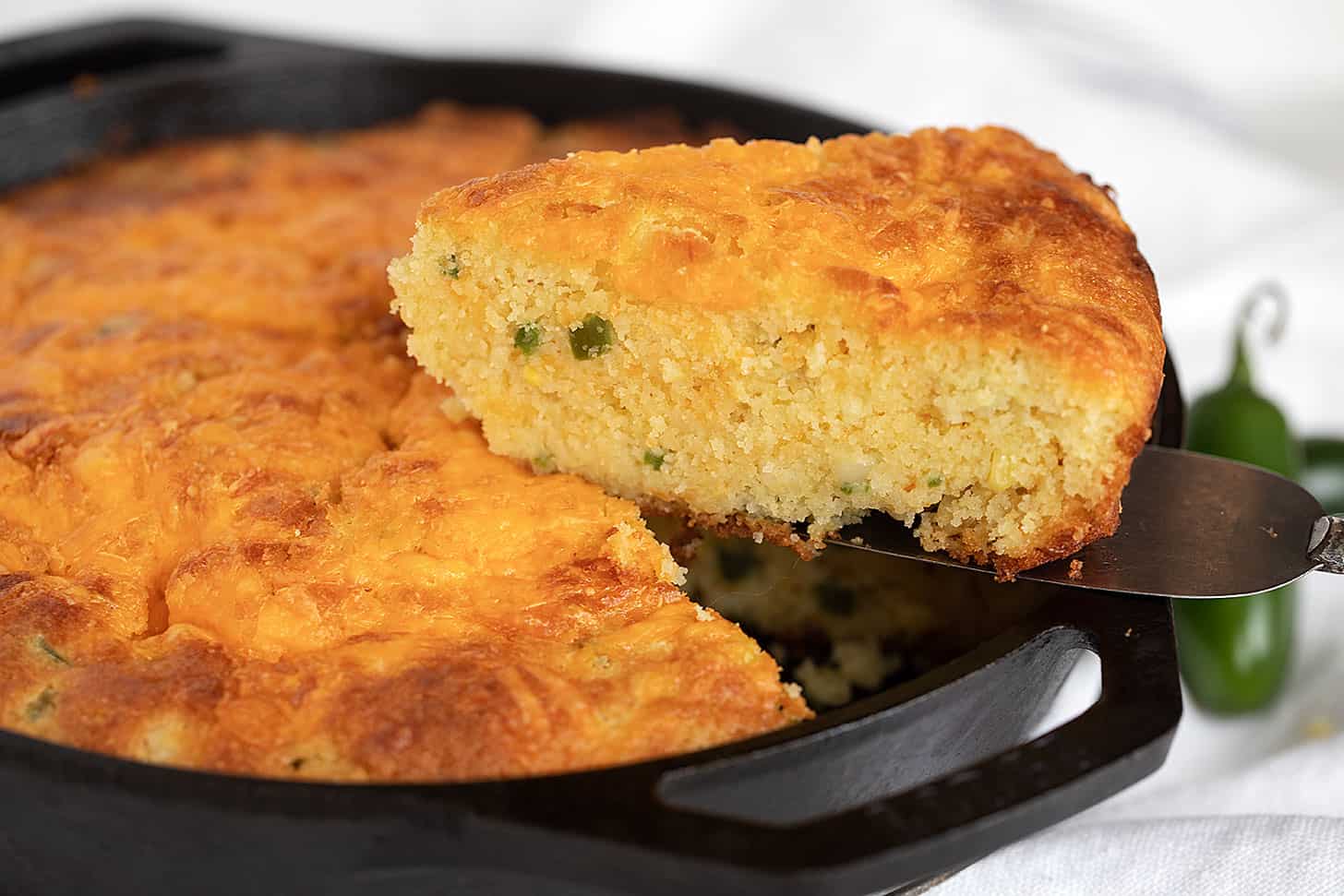 jalapeño cornbread in cast iron skillet sliced