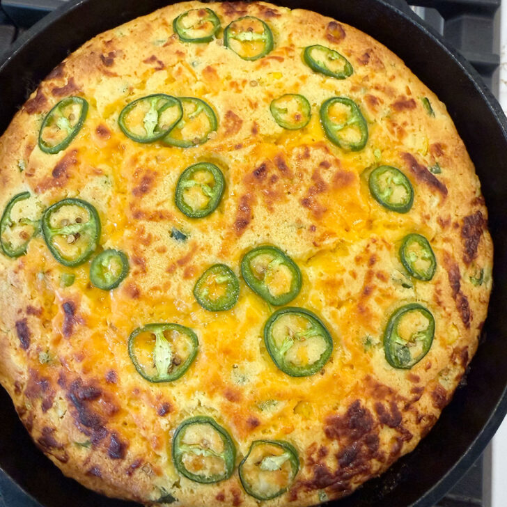 Cast-iron skillet jalapeño cornbread fresh from the oven after baking.