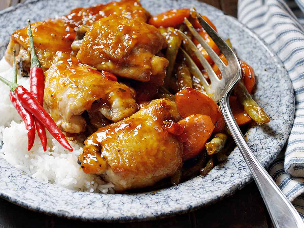 sweet and sour chicken thighs with carrots and rice