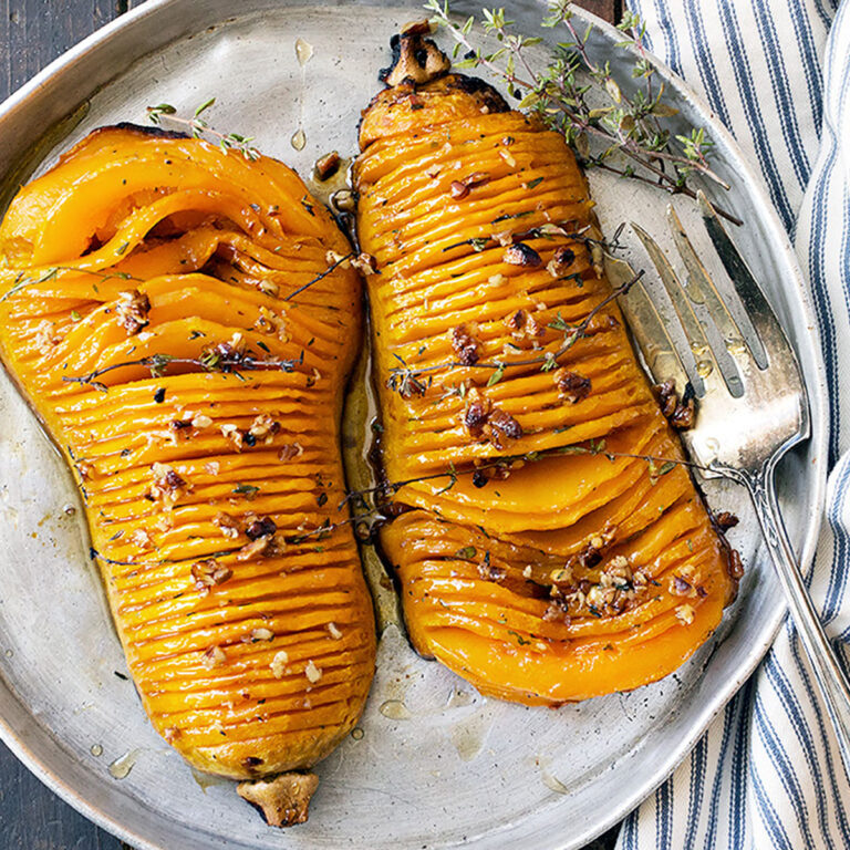 hasselback butternut squash on serving platter with fork