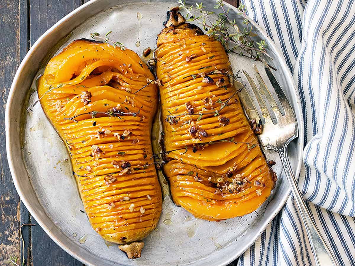 hasselback butternut squash on serving platter with fork
