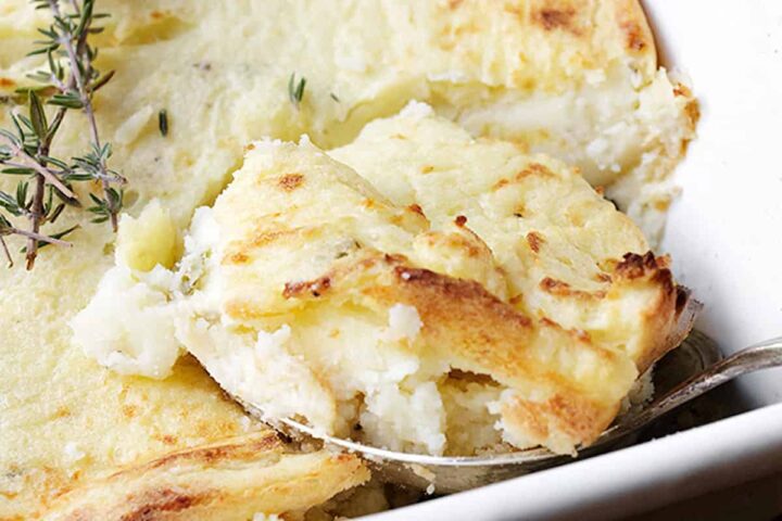 make ahead mashed potato casserole in white dish with spoon