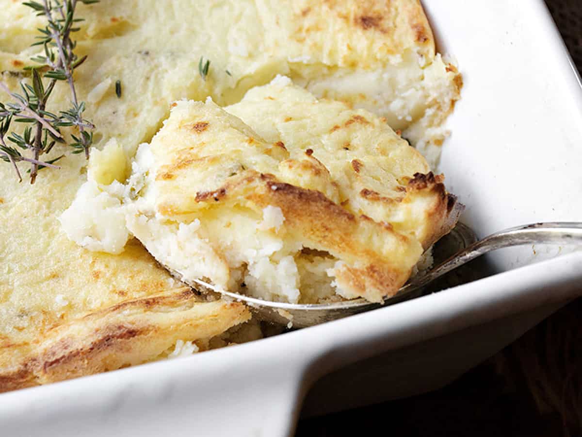 make ahead mashed potato casserole in white dish with spoon