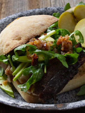 apple braised pork belly sandwich on plate