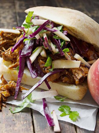 apple pulled pork sandwiches on wooden background