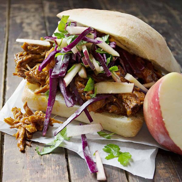 apple pulled pork sandwiches on wooden background