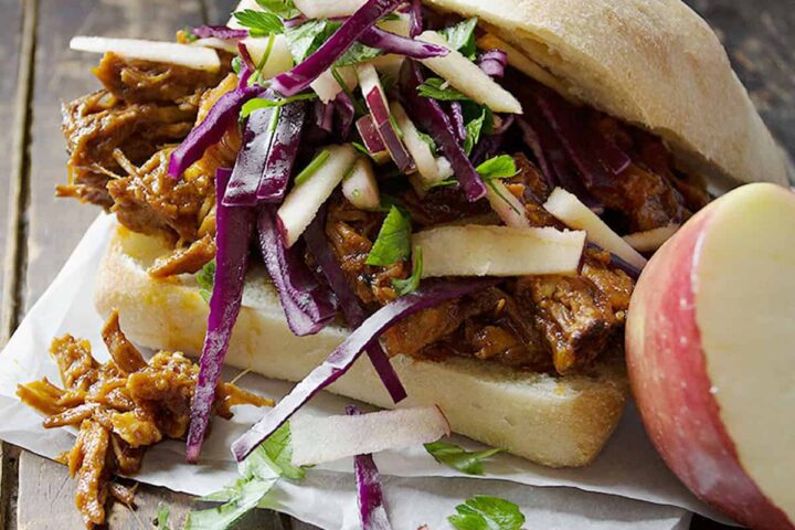 apple pulled pork sandwiches on wooden background
