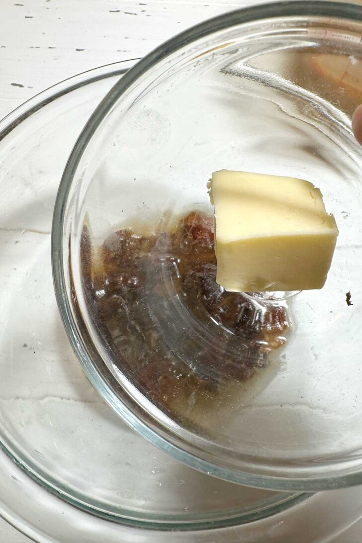 Adding butter to soaking dates.