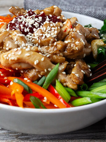 chicken bibimbap in bowl with rice and vegetables