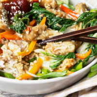 chicken bibimbap in bowl with sesame seeds and vegetables