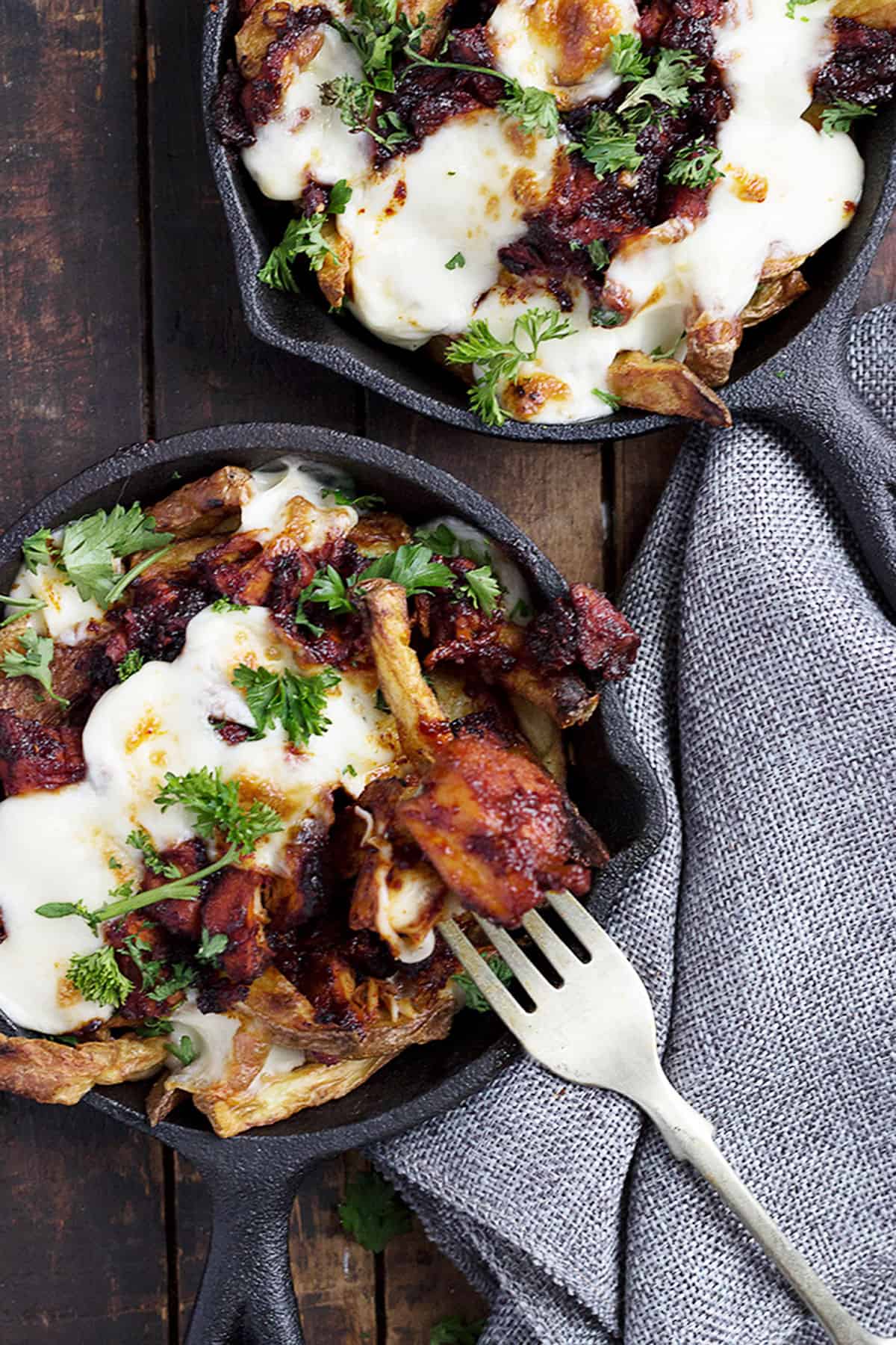 Korean fries with cheese and Fire Chicken in small cast iron skillets