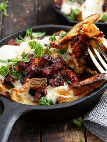 Korean fire chicken cheese fries in small cast iron skillet