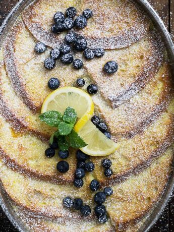 lemon French toast in baking dish with blueberries and lemon slices
