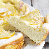 lemon ricotta cake sliced on white plate