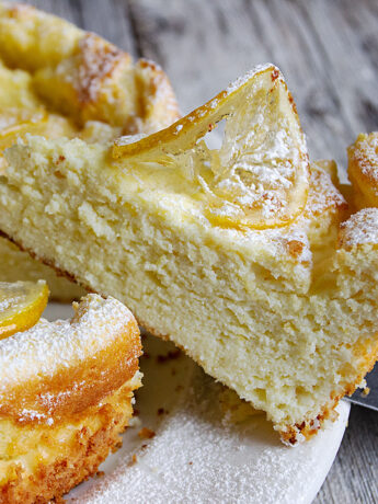 lemon ricotta cake sliced on cake plate