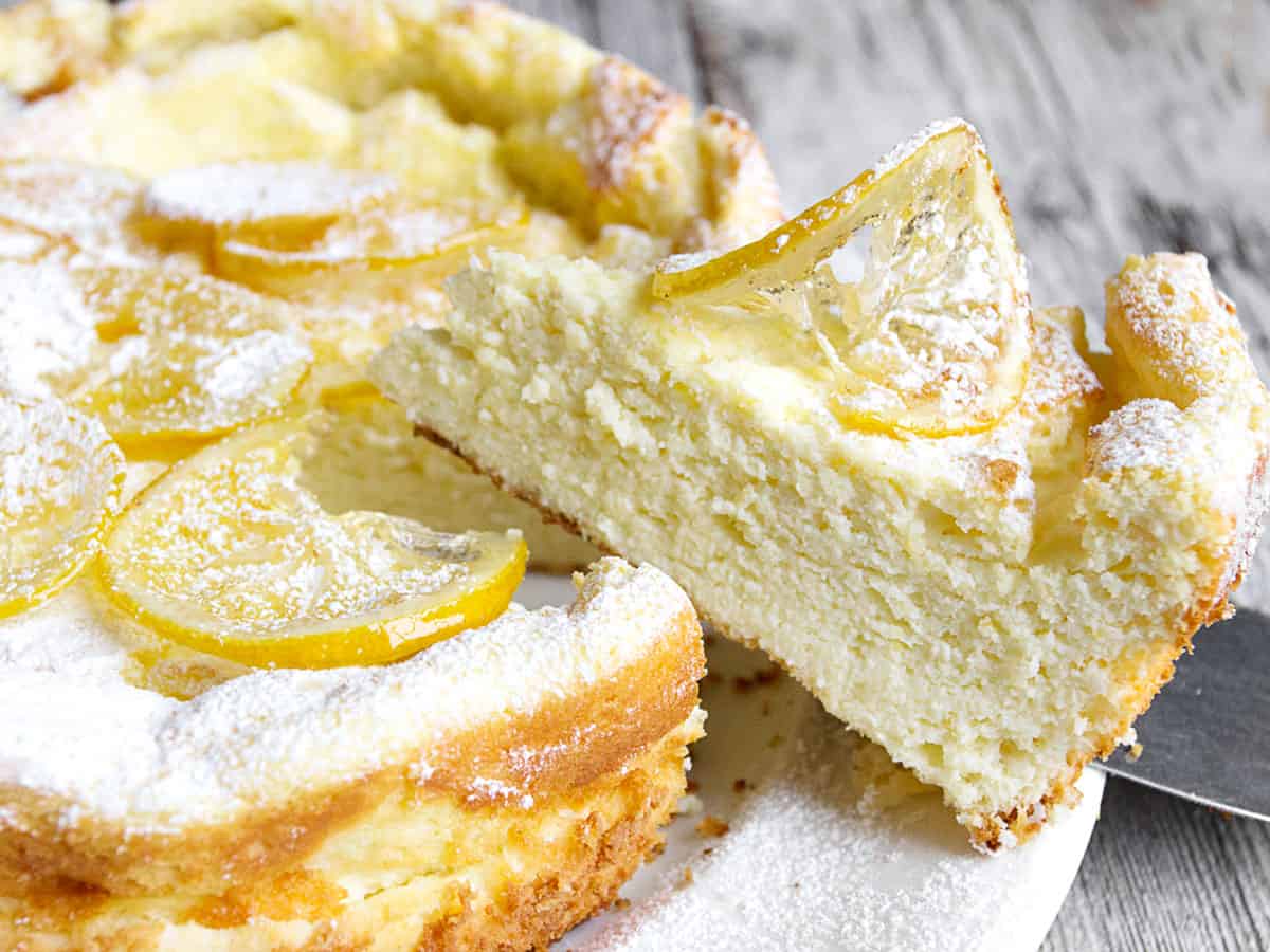 lemon ricotta cake sliced on white plate