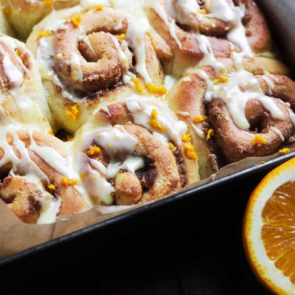 orange cinnamon rolls in baking pan